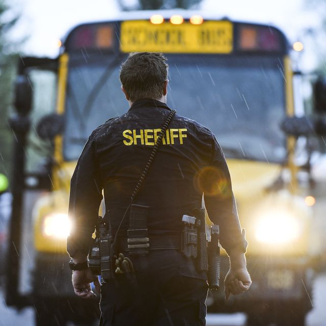 highlands ranch, co   may 07 a sheriffs officer watches as students get off busses after being evacuated to the recreation center at northridge after at least seven students were injured during a shooting at stem school highlands ranch on may 7, 2019 in highlands ranch, colorado photo by michael ciaglogetty images