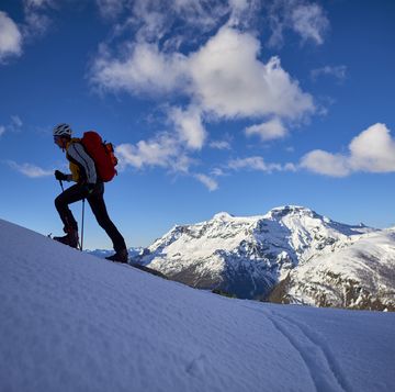 shilouette of a man ski touring in the alps, alpe devero, italy