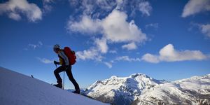 shilouette of a man ski touring in the alps, alpe devero, italy