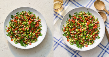 shirazi salad in bowl with chopped cucumbers and chopped tomatoes and fresh herbs