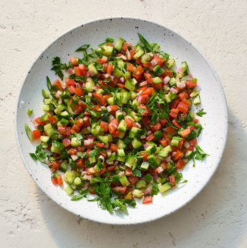 shirazi salad in bowl with chopped cucumbers and chopped tomatoes and fresh herbs shirazi salad in bowl with chopped cucumbers and chopped tomatoes and fresh herbs