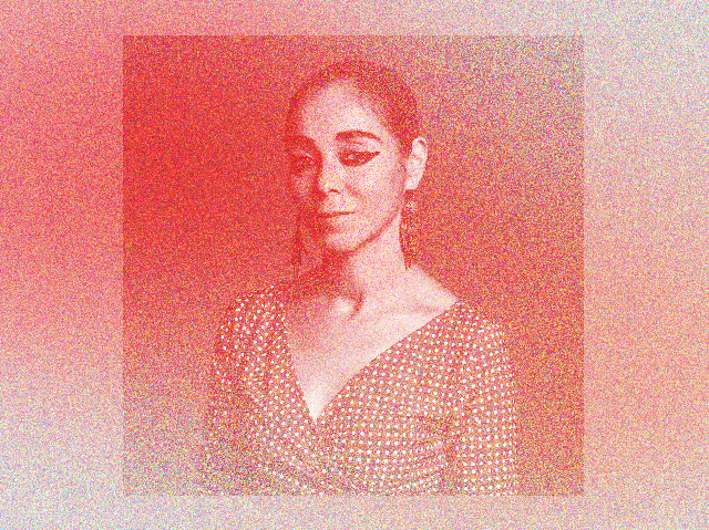 a portrait of iranian artist shirin neshat, looking at the camera wearing heavy eyeliner, with a red gradient over it