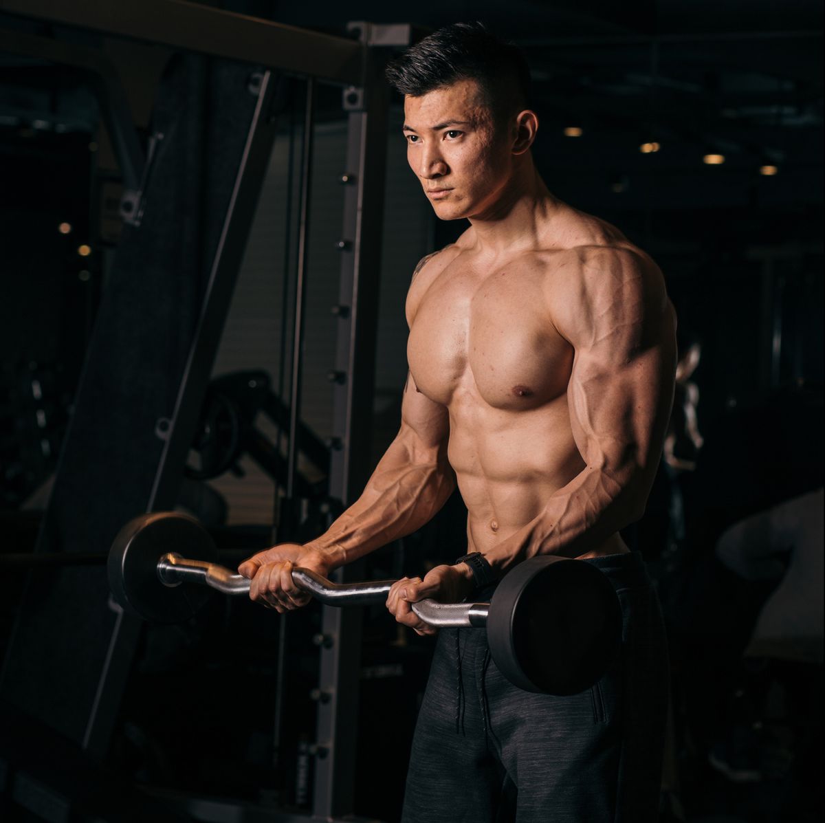 shirtless asian bodybuilder exercising