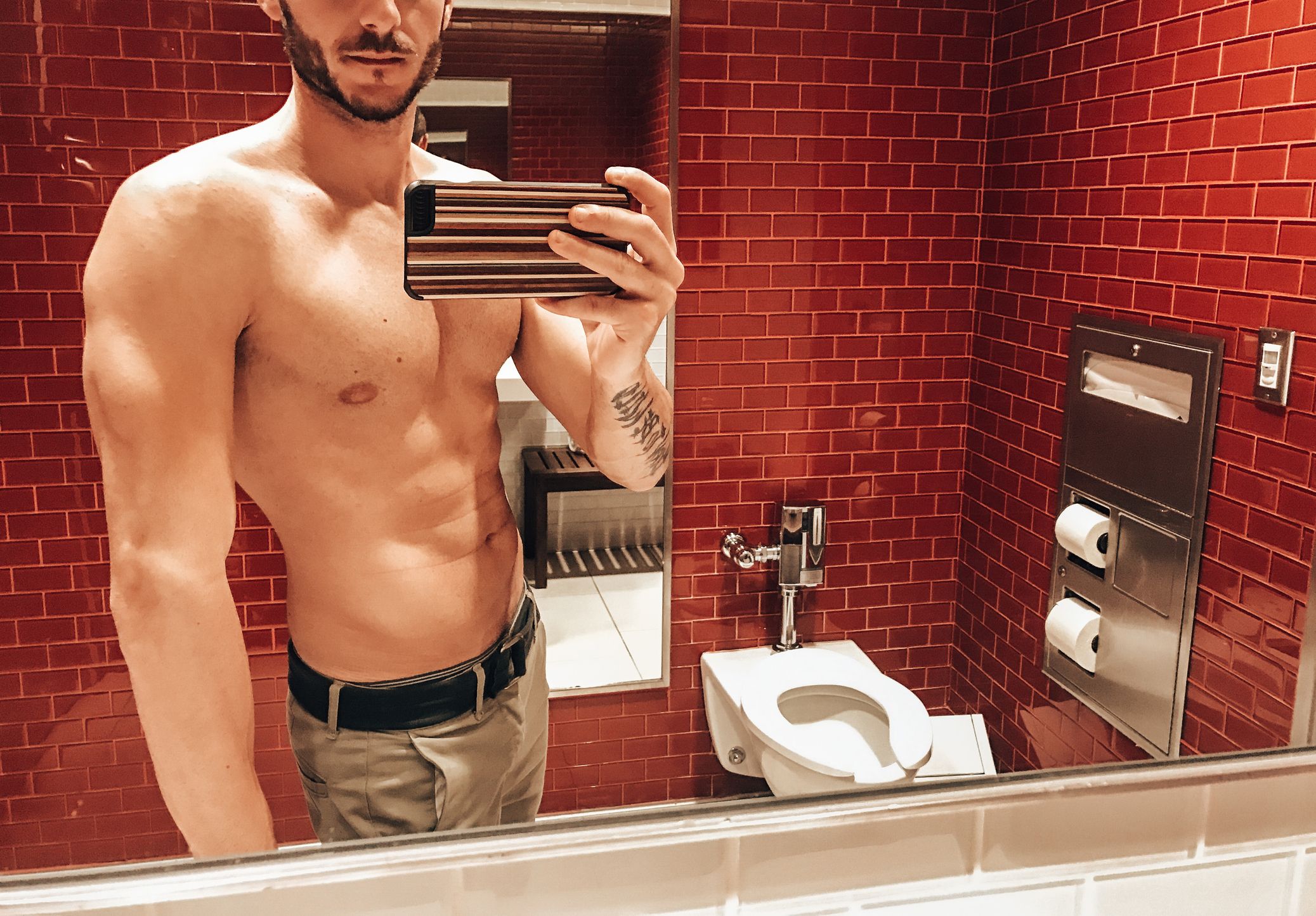 shirtless man take a selfie inside the bathroom royalty free image