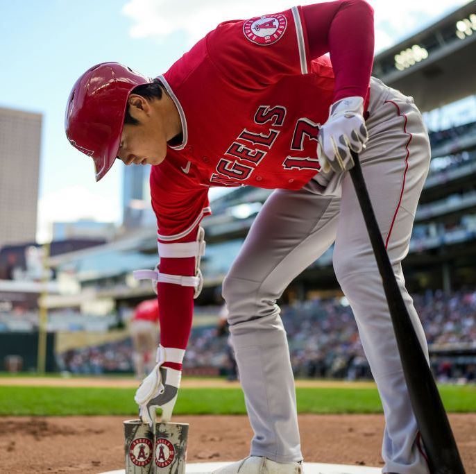 shohei ohtani holding a bat in the on deck circle at a baseball game
