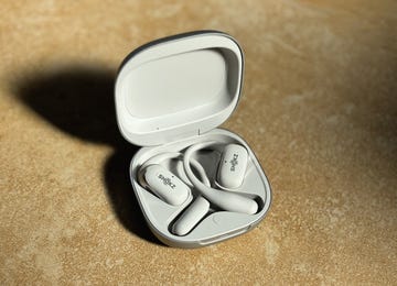 a pair of white earbuds in their charging case