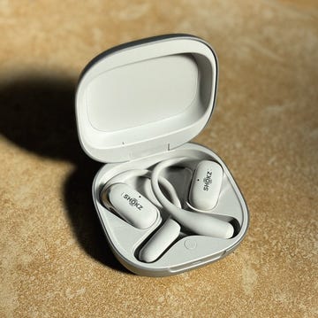 a pair of white earbuds in their charging case a pair of white earbuds in their charging case