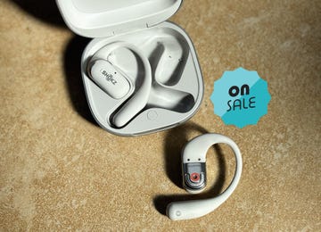 a pair of white open ear headphones on sale