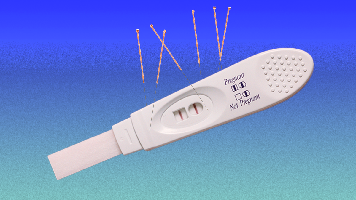 a pregnancy test with acupuncture needles sticking out of it