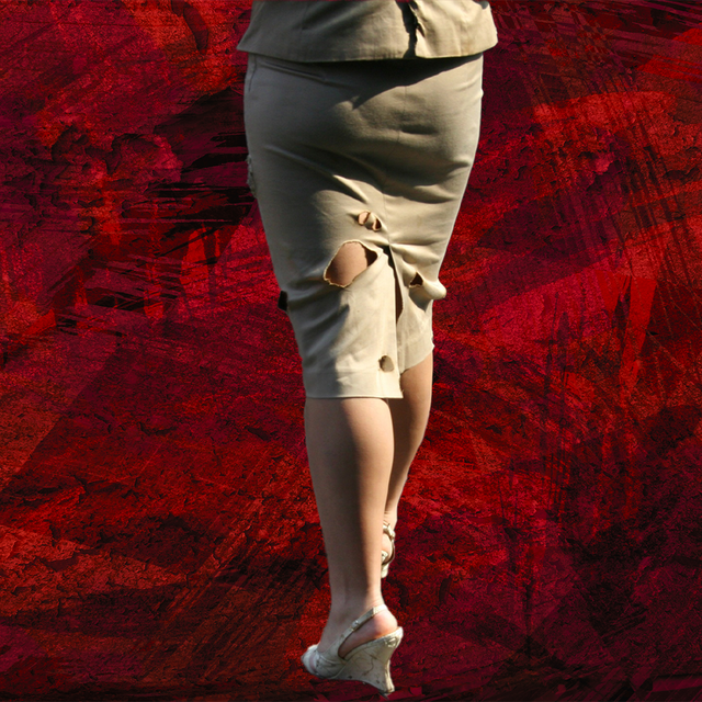 woman in ripped skirt with high heels in front of red background