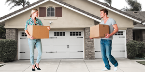 man and woman moving into house