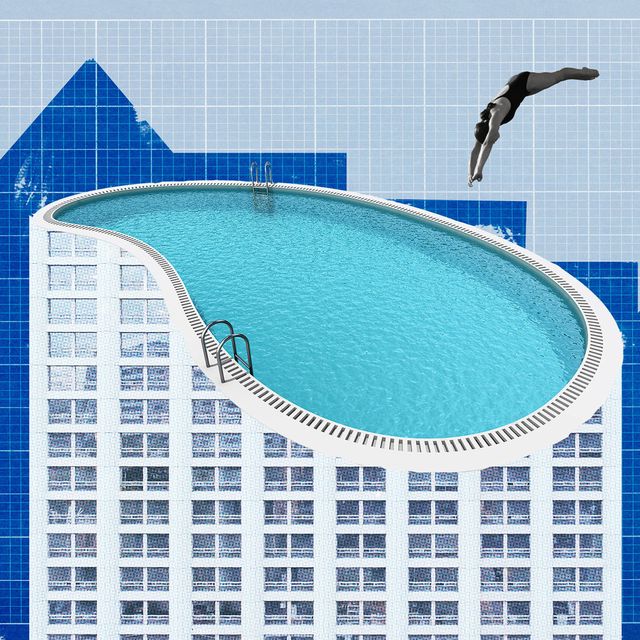 woman diving into pool on top of building