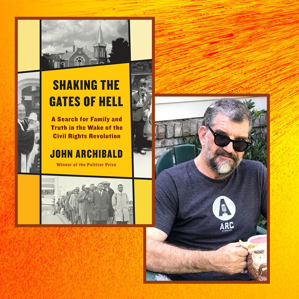 writer john archibald poses next to a copy of his book, shaking the gates of hell