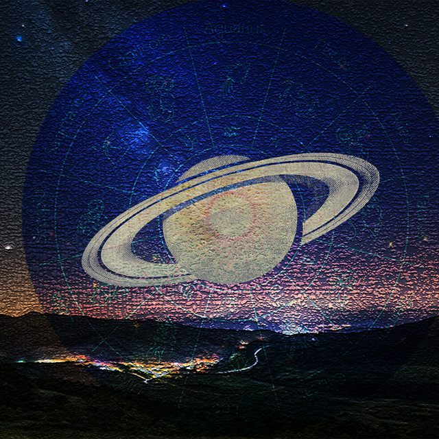 saturn and zodiac wheel over mountains