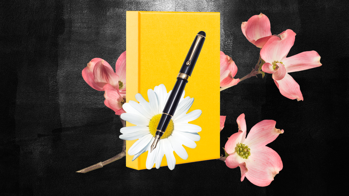 a journal, pen, and flowers