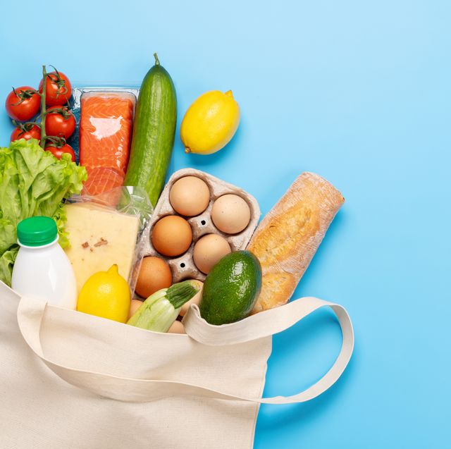 shopping bag full of healthy food on blue