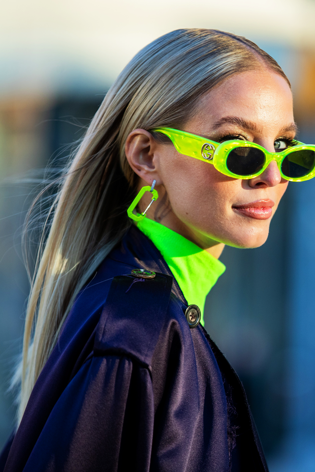 woman wearing neon green sunglasses
