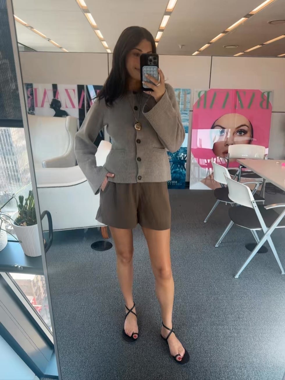 a person in a stylish outfit posing in a modern indoor setting
