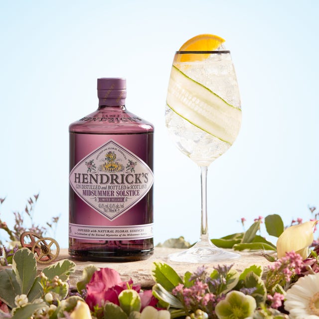 Liquid, Bottle, Petal, Alcoholic beverage, Distilled beverage, Drink, Logo, Glass bottle, Flowering plant, Bottle cap, 