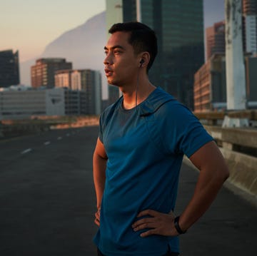 Shot of a handsome young man taking a moment to catch his breath after a morning run in the city shot of a handsome young man taking a moment to catch his breath after a morning run in the city