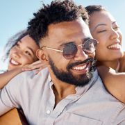 shot of a man at the beach with his two female friends