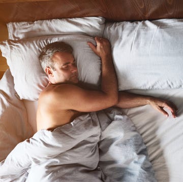 Shot of a mature man sleeping shirtless in his bed shot of a mature man sleeping shirtless in his bed