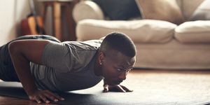 shot of a sporty young man doing push up exercises at home