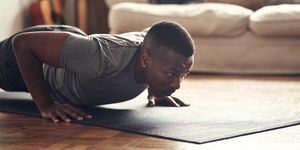shot of a sporty young man doing push up exercises at home