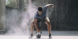 shot of a sporty young man exercising with a kettlebell