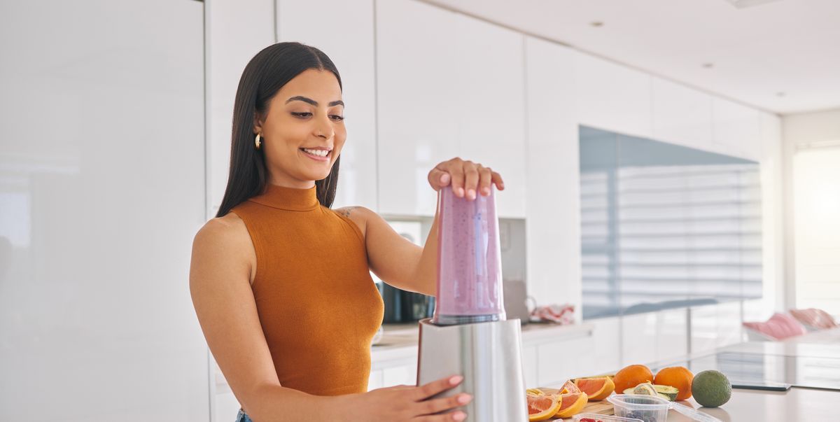 https://hips.hearstapps.com/hmg-prod/images/shot-of-a-woman-preparing-a-smoothie-in-the-kitchen-royalty-free-image-1702420006.jpg?crop=1.00xw:0.774xh;0,0.0652xh&resize=1200:*