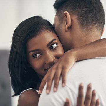shot of a young couple hugging at home