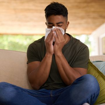 shot of a young man suffering from a cold at home