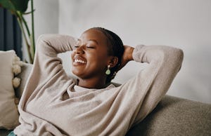 shot of a young woman relaxing on the sofa at home