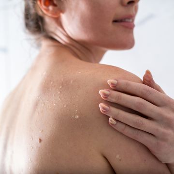 a shoulder of a woman under shower