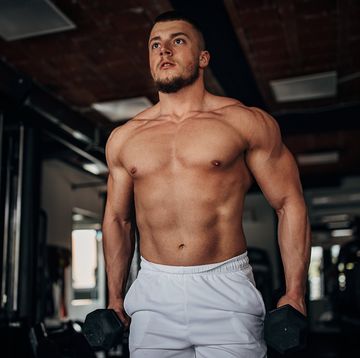 one man, shirtless fit man training with dumbbells in gym alone