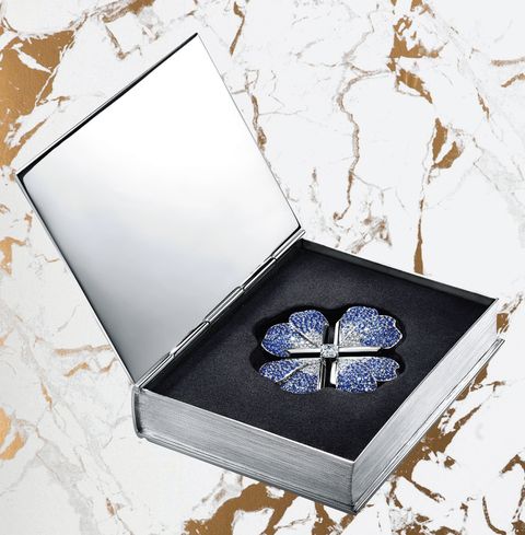 diamond brooch set in a silver box shaped like a book