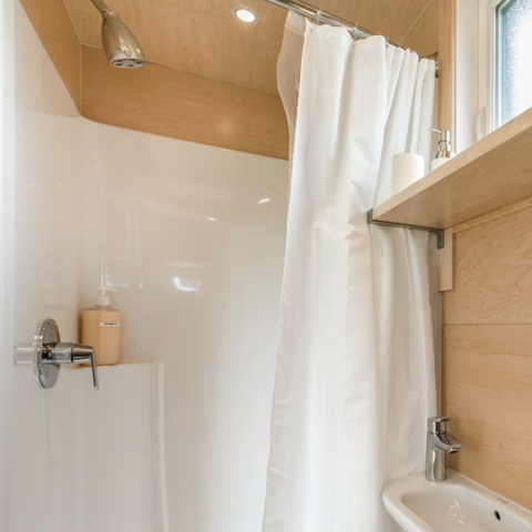 shower in the tiny glass home