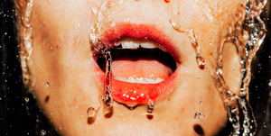 closeup of water rushing down woman's face