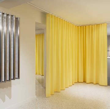 Rubelli by Formafantasma a room with yellow curtains