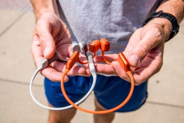 holding shokz openrun and shokz openrun pro 2 headphones