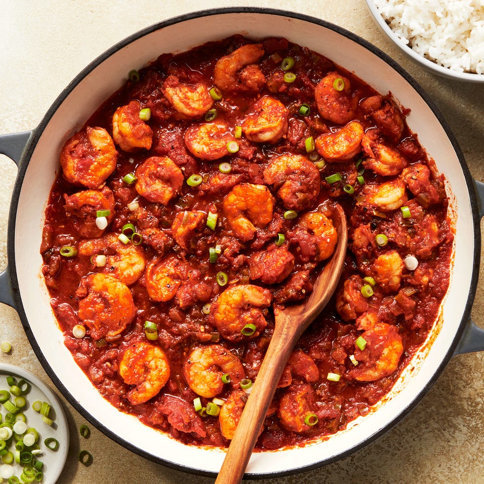 shrimp in a tomato based stew topped with chives and served with rice