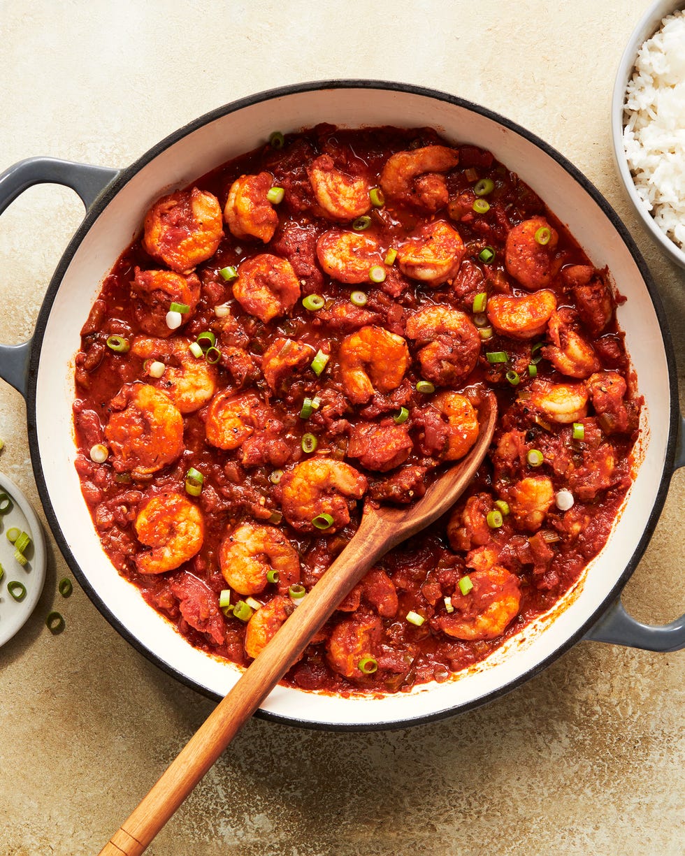 shrimp in a tomato based stew topped with chives and served with rice