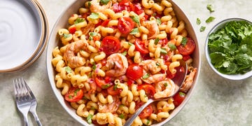 shrimp pasta salad with chopped tomatoes and red onion