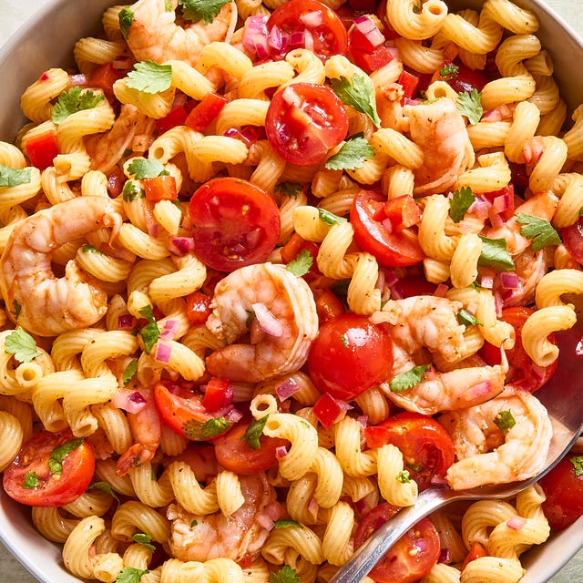 shrimp pasta salad with chopped tomatoes and red onion