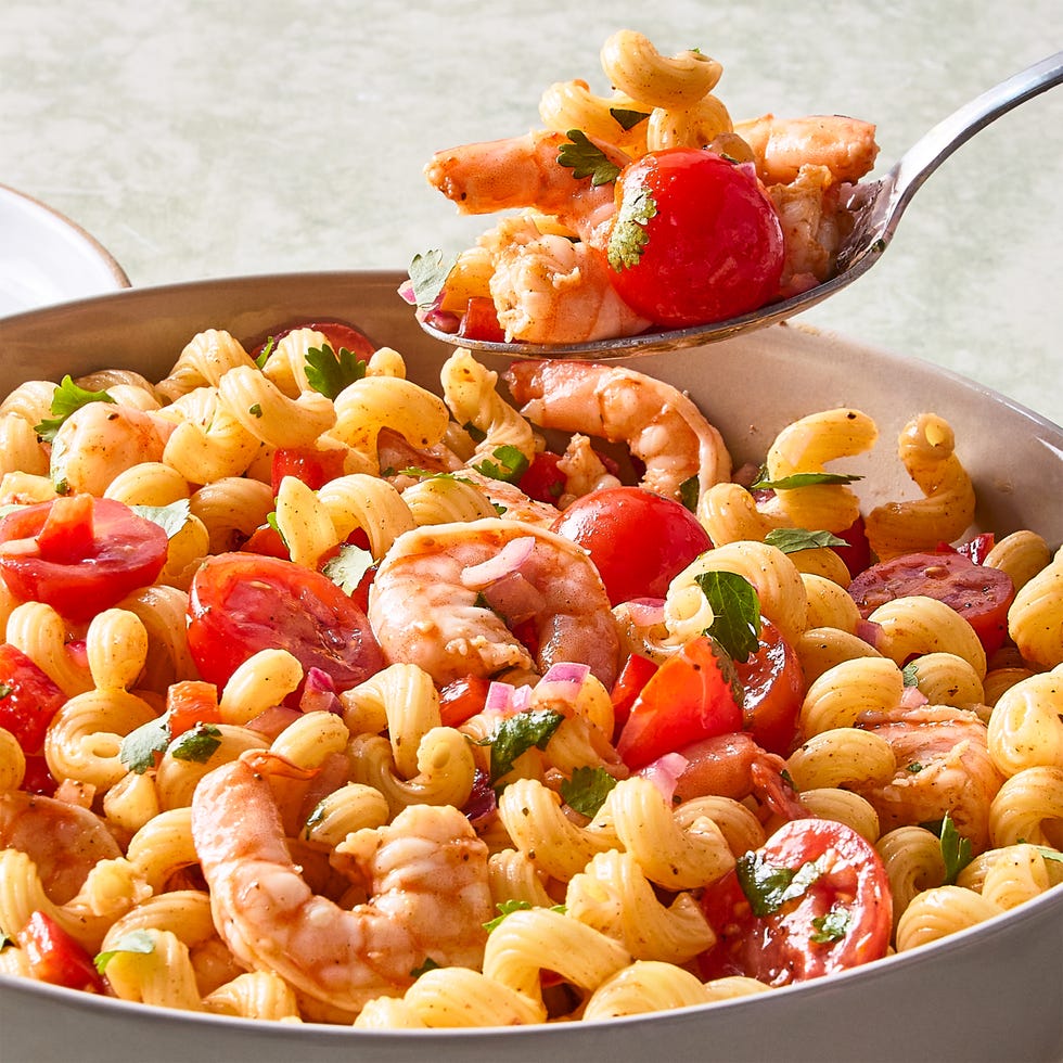 shrimp pasta salad with chopped tomatoes and red onion