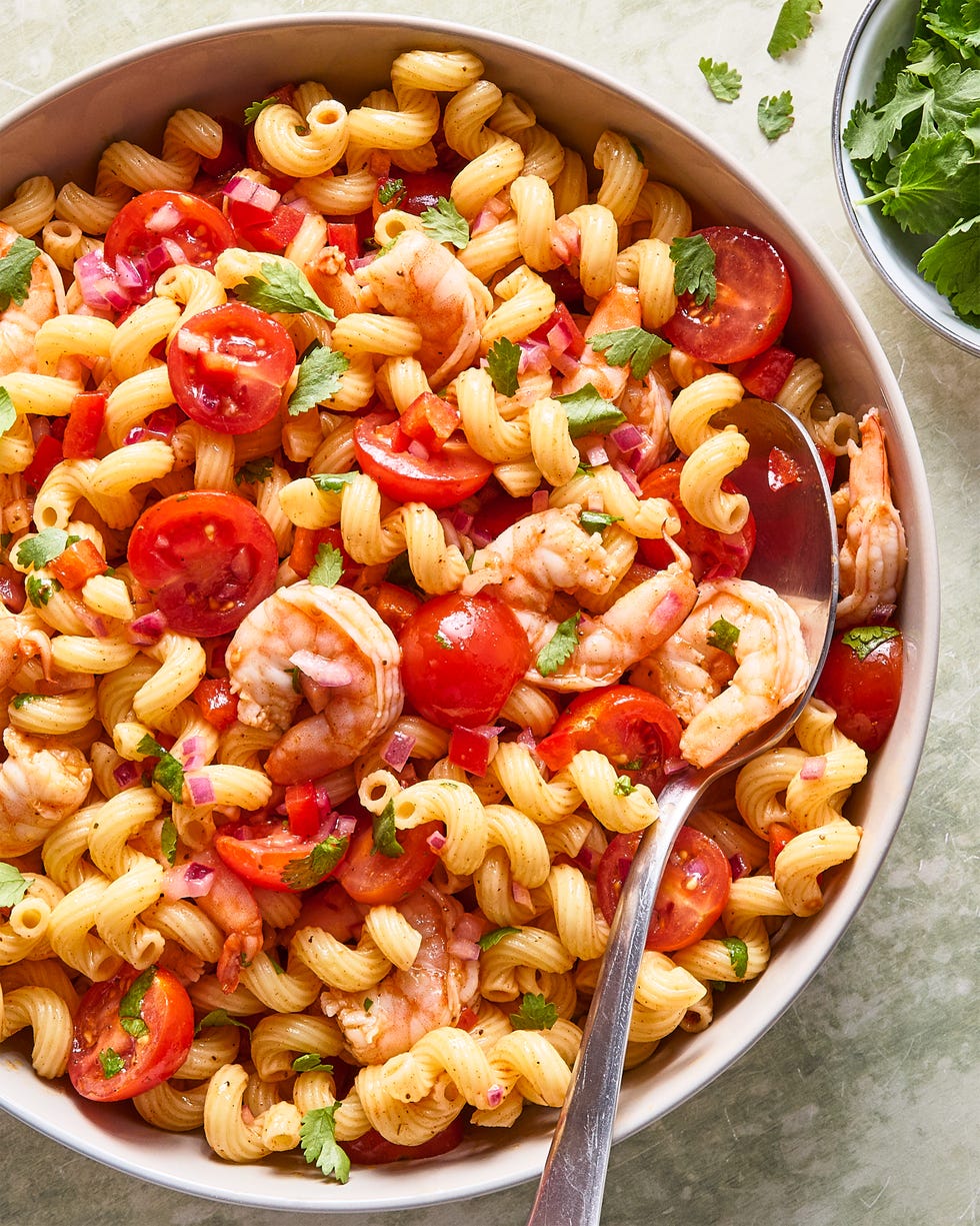 shrimp pasta salad with chopped tomatoes and red onion