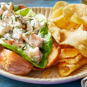 a shrimp salad roll on a plate with potato chips
