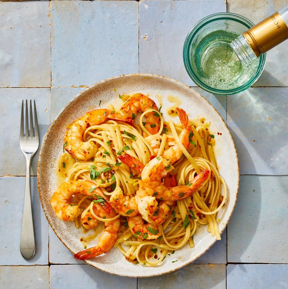 shrimp scampi with linguine on a white plate