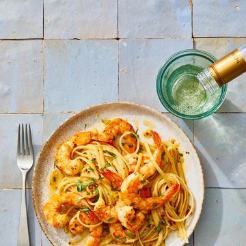 shrimp scampi with linguine on a white plate