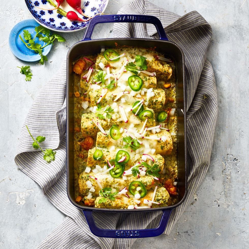 shrimp enchiladas with zucchini and corn on gray striped dish towel